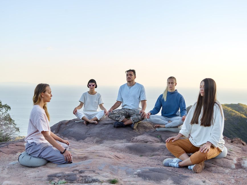 A small group seated in a circle during a guided breathwork session