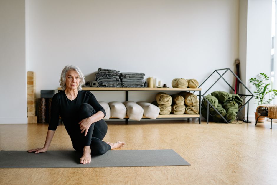 A fully supported restorative yoga pose using blankets and bolsters