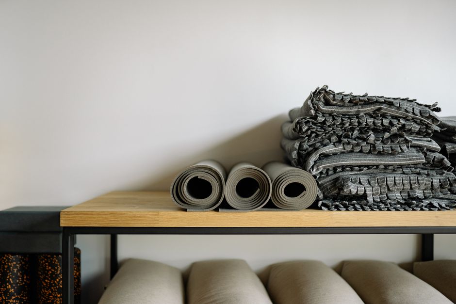 A calm studio set up for yin yoga with blankets and blocks